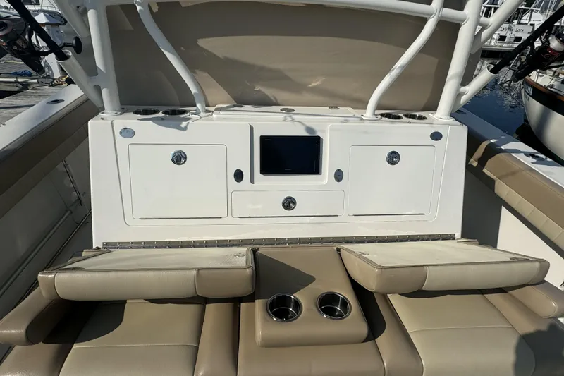 Slide: The Image of 2019 Sailfish 360 CC boat interior with seating, storage, and cup holders. - 16