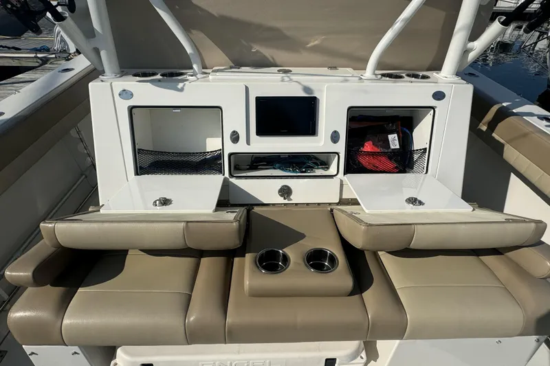 Slide: The Image of 2019 Sailfish 360 CC boat interior with storage compartments and cushioned seating. - 17