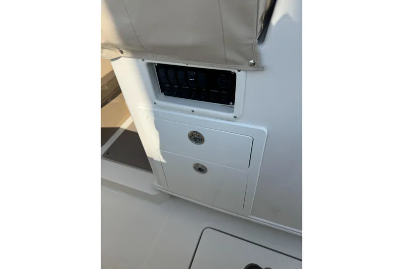 Slide: The Image of Control panel and storage on 2019 Sailfish 360 CC boat. - 19