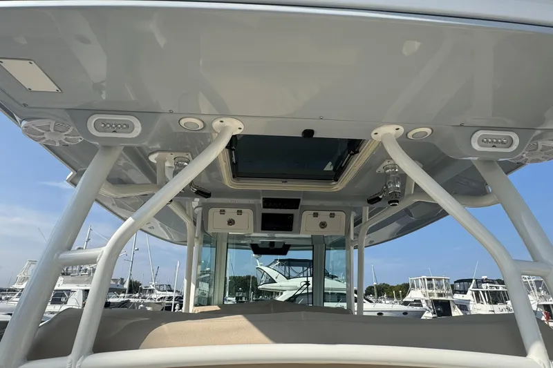 Slide: The Image of 2019 Sailfish 360 CC boat interior with overhead view, showcasing speakers and support structures. - 21