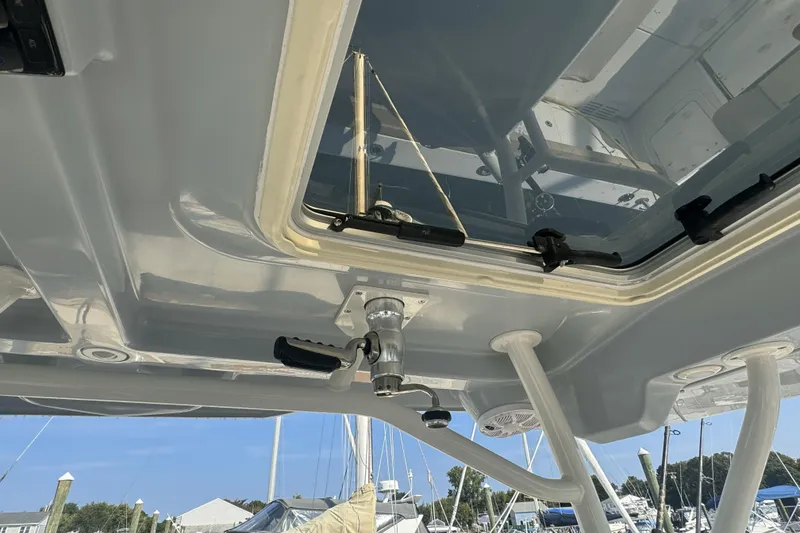 Slide: The Image of 2019 Sailfish 360 CC boat roof hatch with handle and latches, docked at marina. - 22