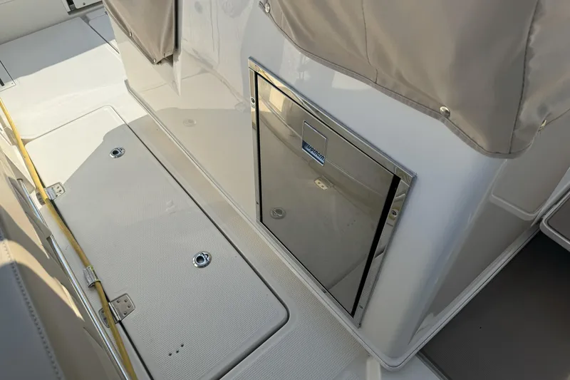 Slide: The Image of 2019 Sailfish 360 CC boat interior with storage compartment and seating area. - 23