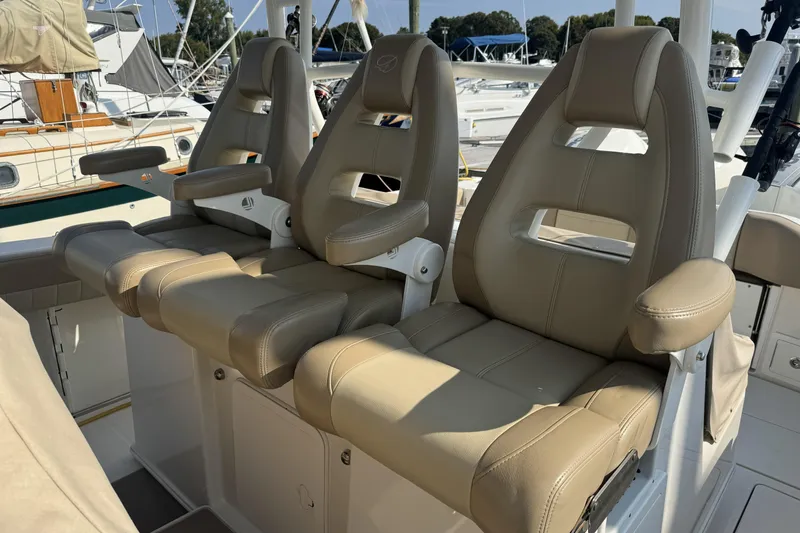 Slide: The Image of Three beige captain's chairs on a 2019 Sailfish 360 CC boat. - 25
