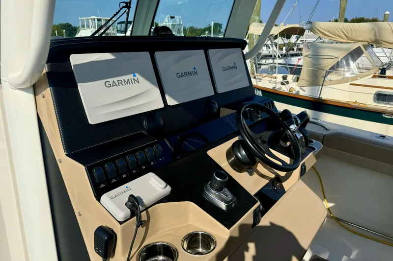 Slide: The Image of Helm of 2019 Sailfish 360 CC with Garmin navigation displays and controls. - 27