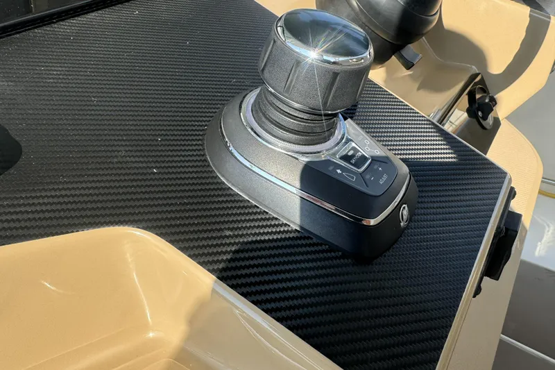 Slide: The Image of Joystick control on 2019 Sailfish 360 CC boat dashboard with carbon fiber finish. - 28