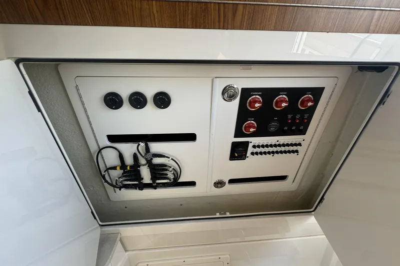 Slide: The Image of Electrical panel of a 2019 Sailfish 360 CC boat, featuring switches and wiring. - 29