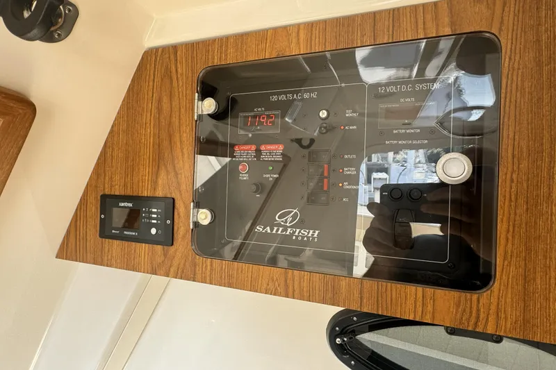 Slide: The Image of Control panel of a 2019 Sailfish 360 CC boat, featuring electrical system displays. - 30