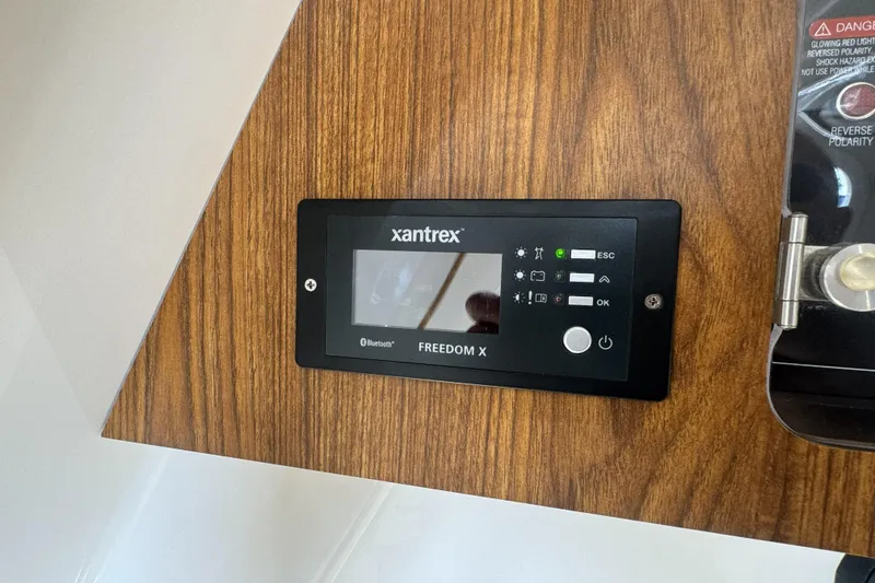 Slide: The Image of Xantrex Freedom X control panel on 2019 Sailfish 360 CC boat interior. - 31
