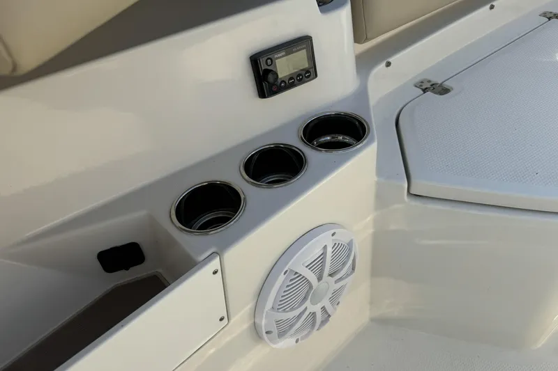 Slide: The Image of 2019 Sailfish 360 CC boat interior with cup holders, speaker, and control panel. - 33