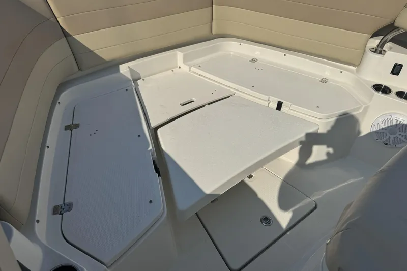 Slide: The Image of 2019 Sailfish 360 CC boat interior with seating and storage compartments. - 34