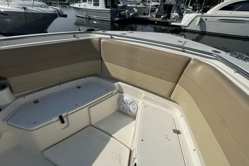 Slide: The Image of 2019 Sailfish 360 CC boat interior with beige seating and storage compartments. - 36
