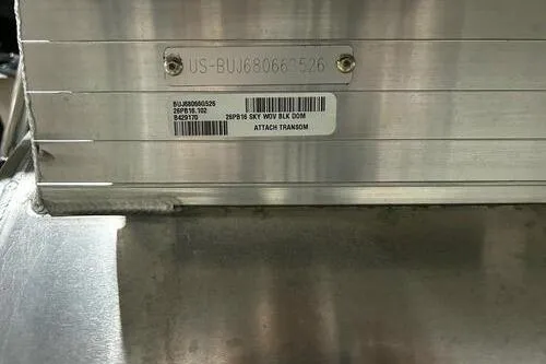 Slide: The Image of 2026 Sun Tracker Party Barge 16 DLX identification plate on metallic surface. - 11