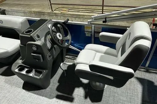 Slide: The Image of 2026 Sun Tracker Party Barge 16 DLX interior with steering console and captain's chair. - 8