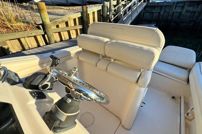 Slide: The Image of 2018 Grady-White Fisherman 216 boat interior with steering wheel and seating. - 11