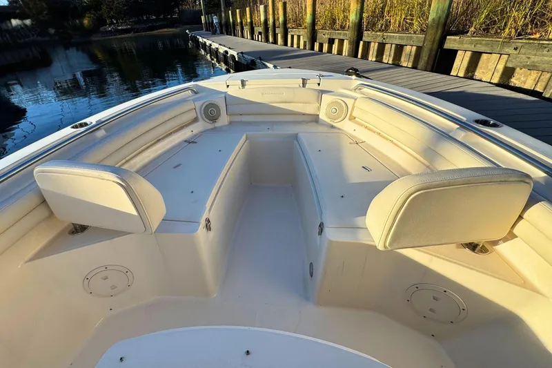 Slide: The Image of 2018 Grady-White Fisherman 216 boat interior with cushioned seating and speakers at dock. - 19