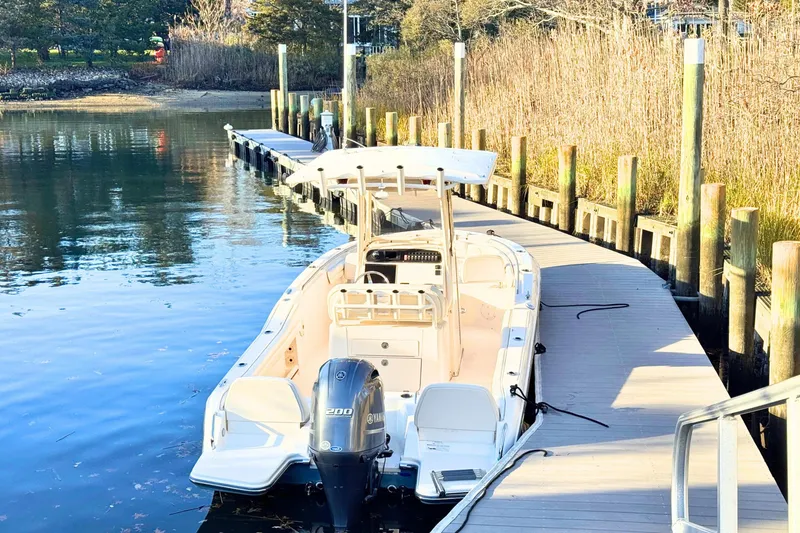 Slide: The Image of 2018 Grady-White Fisherman 216 boat docked by a wooden pier in a serene setting. - 3