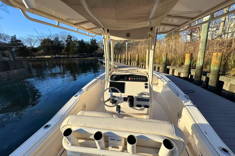 Slide: The Image of 2018 Grady-White Fisherman 216 boat docked, showcasing helm and seating area. - 9