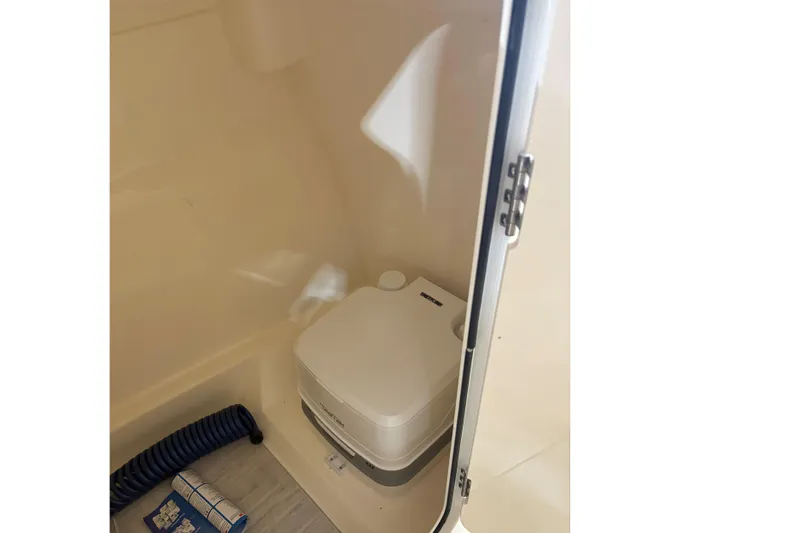 Slide: The Image of Interior of 2024 Scout 215 Dorado featuring portable toilet. - 12