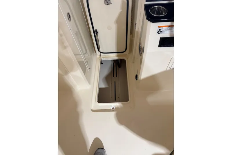 Slide: The Image of 2024 Scout 215 Dorado boat interior storage compartment with open hatch. - 14