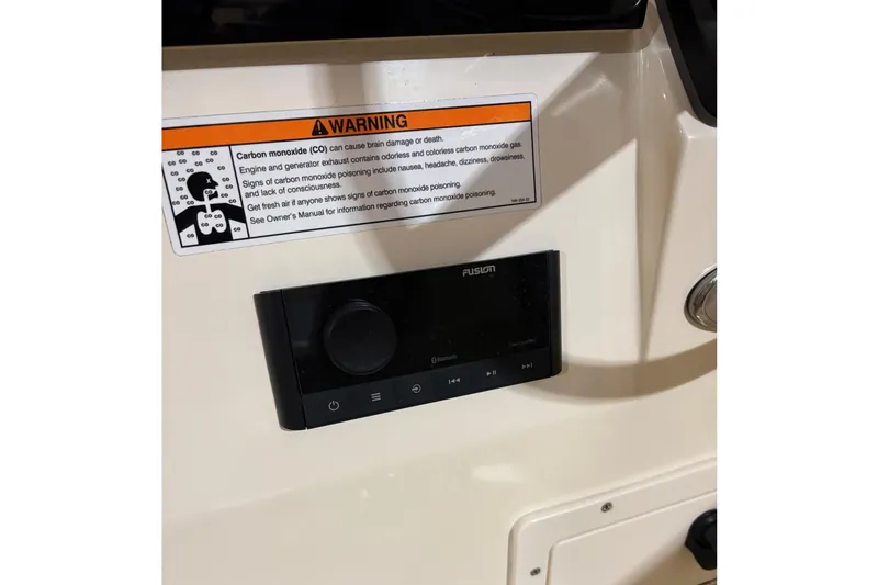 Slide: The Image of 2024 Scout 215 Dorado boat console with warning label and controls. - 17