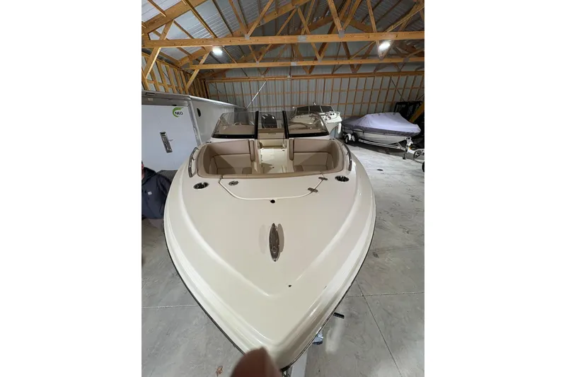 Slide: The Image of 2024 Scout 215 Dorado boat in storage, showcasing sleek design and spacious interior. - 2