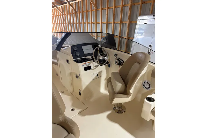 Slide: The Image of 2024 Scout 215 Dorado boat interior with steering wheel and Garmin display. - 7