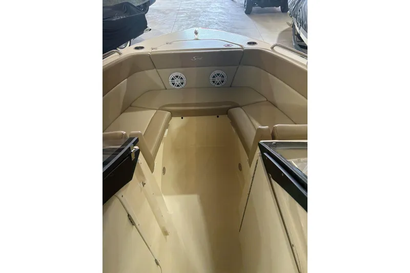 Slide: The Image of 2024 Scout 215 Dorado boat interior with beige seating and speaker system. - 8