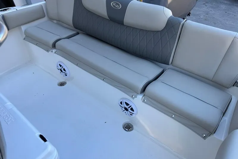 Slide: The Image of 2026 Key West 219 FS boat interior with cushioned seating and built-in speakers. - 23