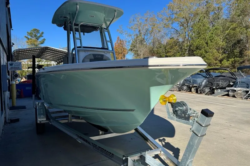 Slide: The Image of 2026 Key West 219 FS boat on trailer, parked outdoors near service entrance. - 6