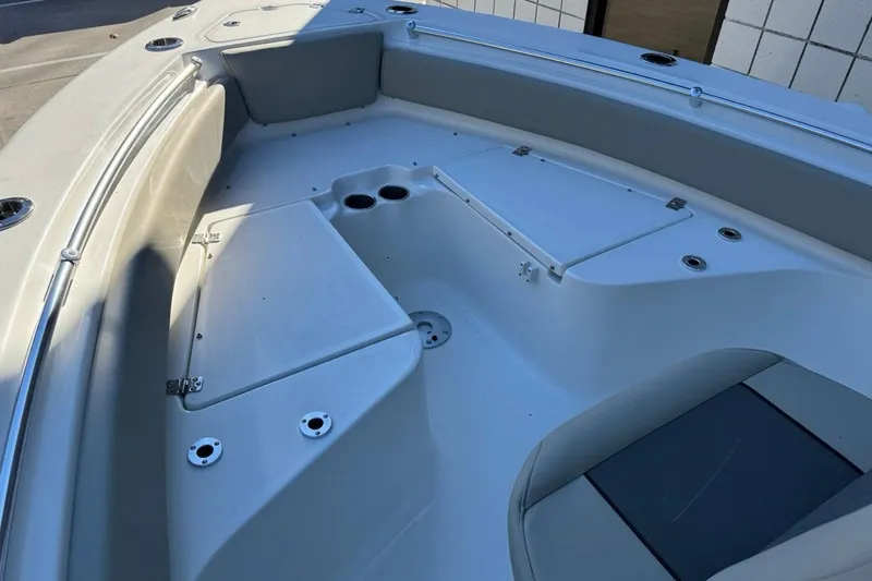 Slide: The Image of 2026 Key West 219 FS boat interior with seating and storage compartments. - 9