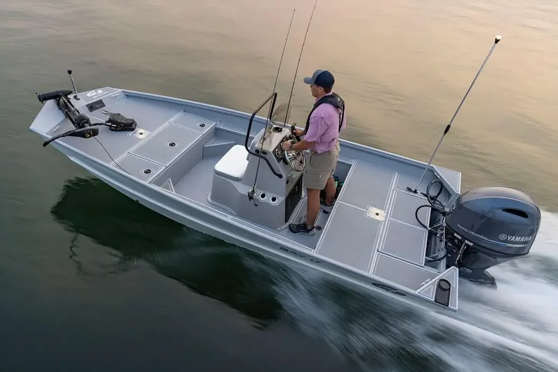 Slide: The Image of Manufacturer Provided Image: Man steering 2026 G3 Bay 17 boat on calm water. - 1