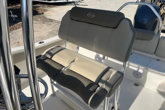 Slide: The Image of 2023 Key West 219 FS boat interior with cushioned seating and steering wheel. - 10