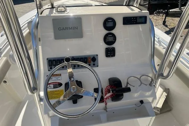 Slide: The Image of 2023 Key West 219 FS boat console with Garmin navigation and steering wheel. - 11