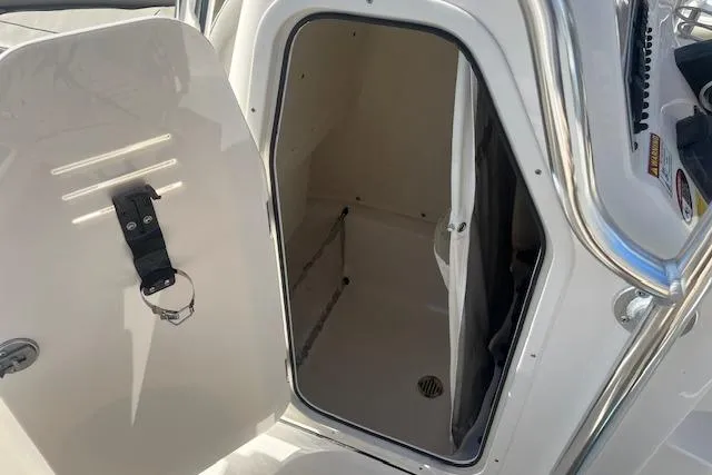 Slide: The Image of 2023 Key West 219 FS boat interior storage compartment with open door. - 12