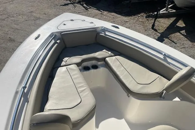 Slide: The Image of 2023 Key West 219 FS boat interior with cushioned seating and cup holders. - 13