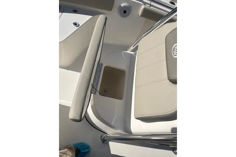 Slide: The Image of 2023 Key West 219 FS boat interior with cushioned seating and storage compartment. - 17