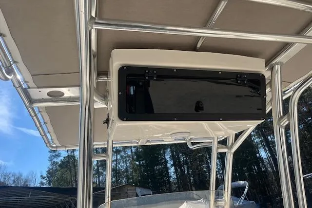 Slide: The Image of 2023 Key West 219 FS boat T-top with storage compartment, set against a clear sky. - 18