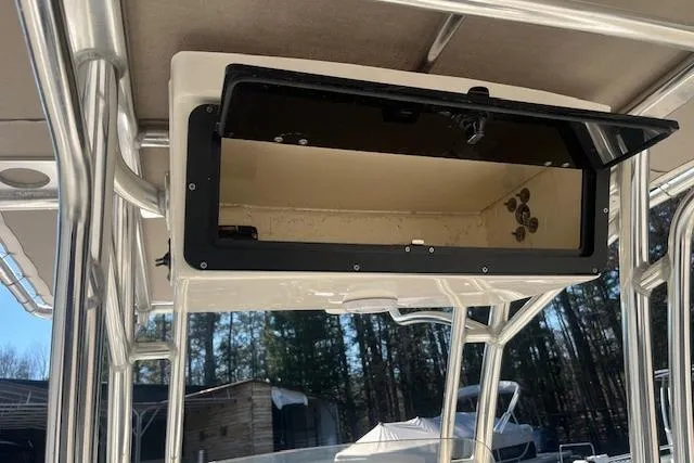 Slide: The Image of 2023 Key West 219 FS boat storage compartment with open lid, showcasing interior space. - 19