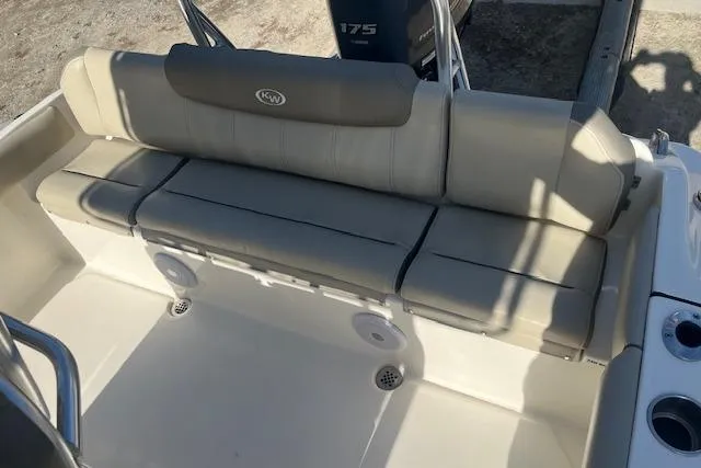 Slide: The Image of 2023 Key West 219 FS boat with beige seating and cup holders. - 5