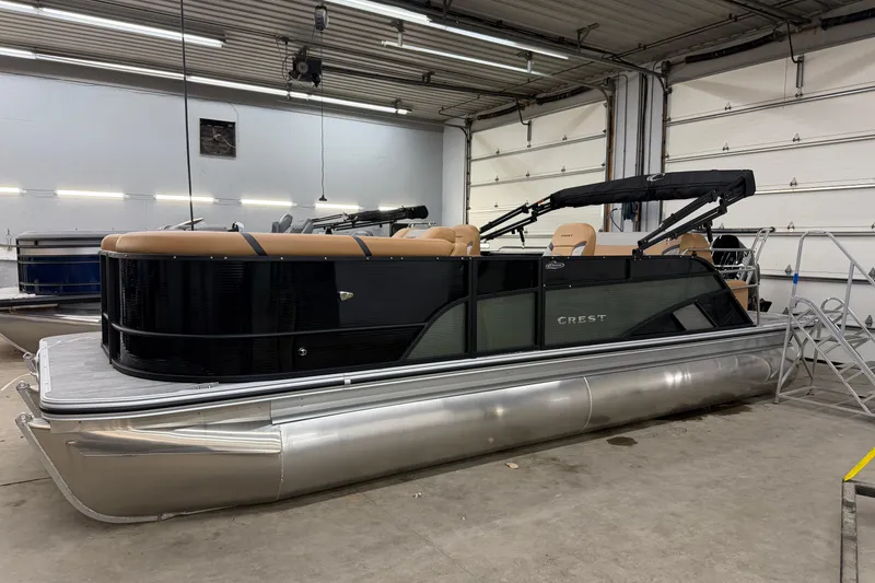 The Image of 2025 Crest Classic 220 SLSC pontoon boat in a garage setting. - 1