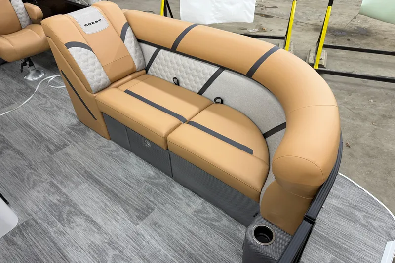 Slide: The Image of 2025 Crest Classic 220 SLSC boat seating with tan and gray upholstery. - 3
