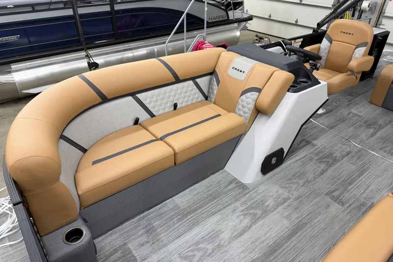 Slide: The Image of 2025 Crest Classic 220 SLSC boat interior with tan seating and modern design. - 4