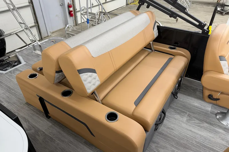 Slide: The Image of 2025 Crest Classic 220 SLSC boat interior with tan seating and cup holders. - 8