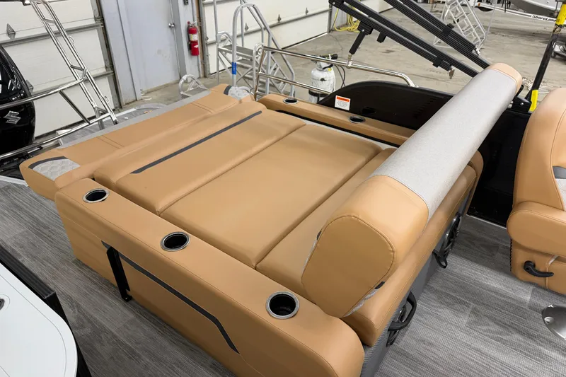 Slide: The Image of 2025 Crest Classic 220 SLSC boat interior with tan seating and cup holders. - 9