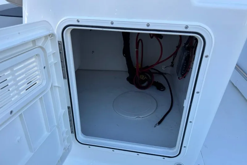 Slide: The Image of Open storage compartment on 2026 Key West 1720 Center Console boat, showing interior wiring. - 10