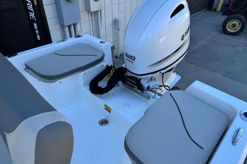 Slide: The Image of 2026 Key West 1720 Center Console boat with Yamaha outboard motor, docked outdoors. - 11