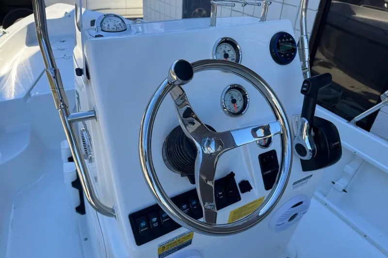 Slide: The Image of 2026 Key West 1720 Center Console boat dashboard with steering wheel and gauges. - 12