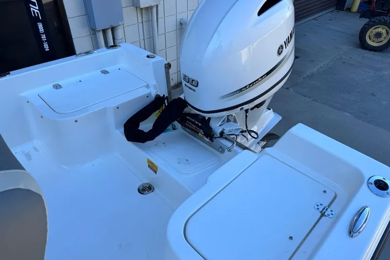 Slide: The Image of 2026 Key West 1720 Center Console boat with Yamaha outboard motor, docked outdoors. - 14
