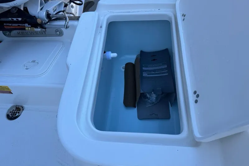 Slide: The Image of Open storage compartment on 2026 Key West 1720 Center Console boat. - 15