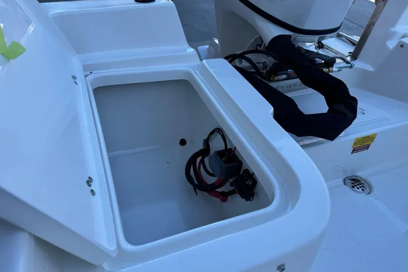 Slide: The Image of 2026 Key West 1720 Center Console boat storage compartment with open lid. - 16
